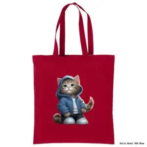 A red tote bag featuring an illustration of a cute brown tabby cat wearing a blue hoodie, blue jeans, and white sneakers. The cat has large blue eyes, an innocent expression, and is sitting upright on the front of the bag.