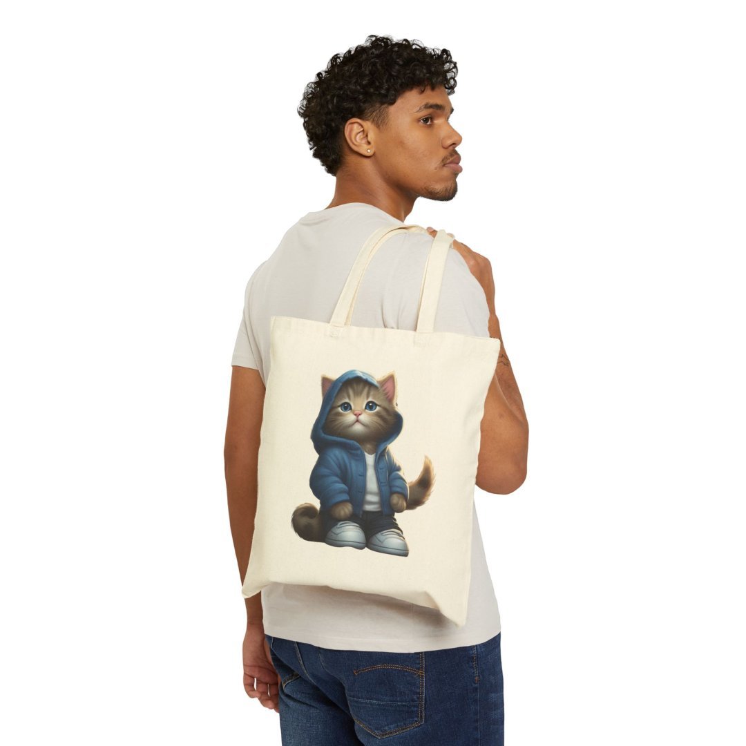 14654378799600149905_2048.jpeg Man carrying a tote bag with a cat in a hoodie design.