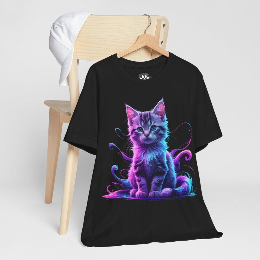 14772209320806574580_2048.jpeg Black t-shirt with a colorful cat design on a wooden chair.
