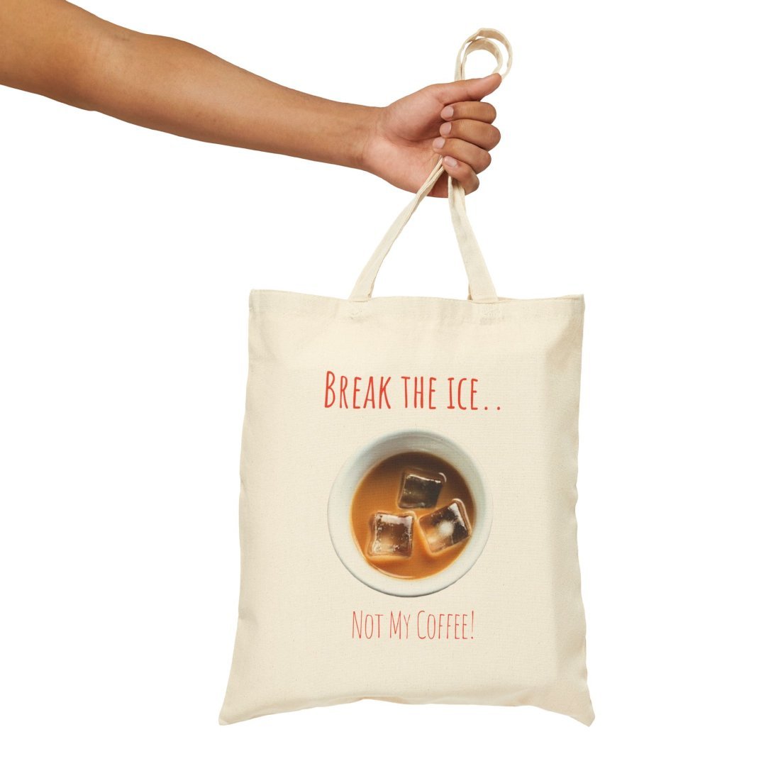 16195049505140439087_2048.jpeg Hand holding a tote bag with a coffee design and text.