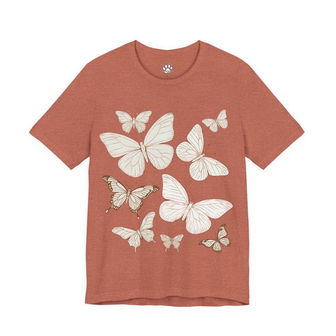 17671921920717917646_2048.jpeg Rust-colored t-shirt with white butterfly illustrations.