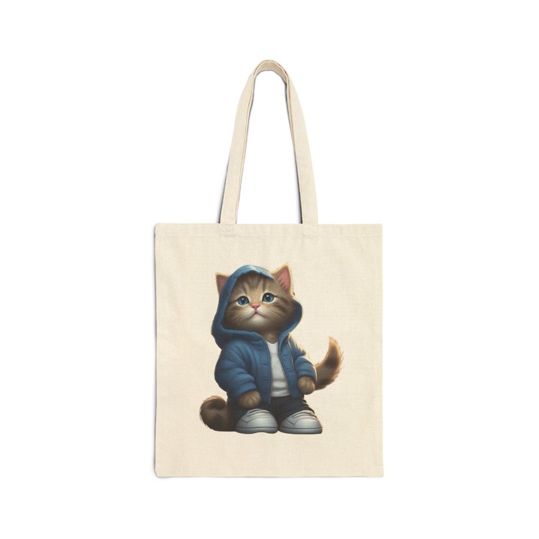 1782767428785236091_2048.jpeg Tote bag with a cute cat in a blue hoodie and sneakers.