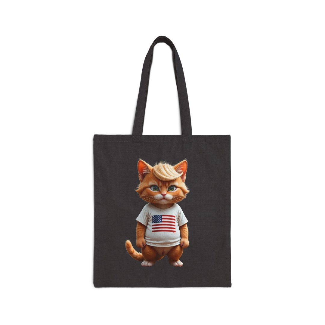Cute American Flag Kitty Canvas Tote. Cute cartoon cat wearing a shirt with the American flag on a black tote bag.