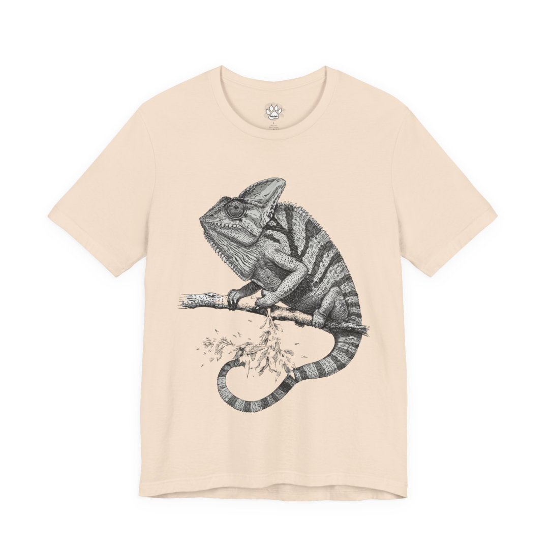 619886929848685559_2048.jpeg Beige t-shirt with a detailed chameleon illustration on a branch.