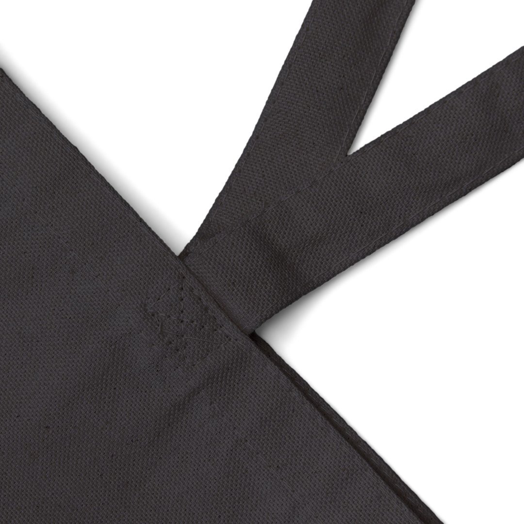 1030109226558217690_2048.jpeg Close-up of a black fabric tote bag with sturdy handles.