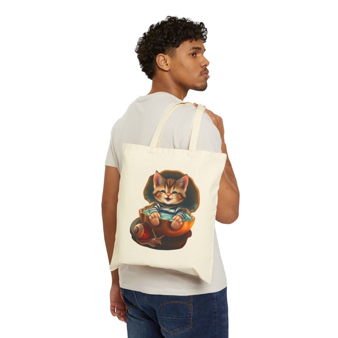 10471060994727255424_2048.jpeg Man carrying a tote bag with a cute kitten design.