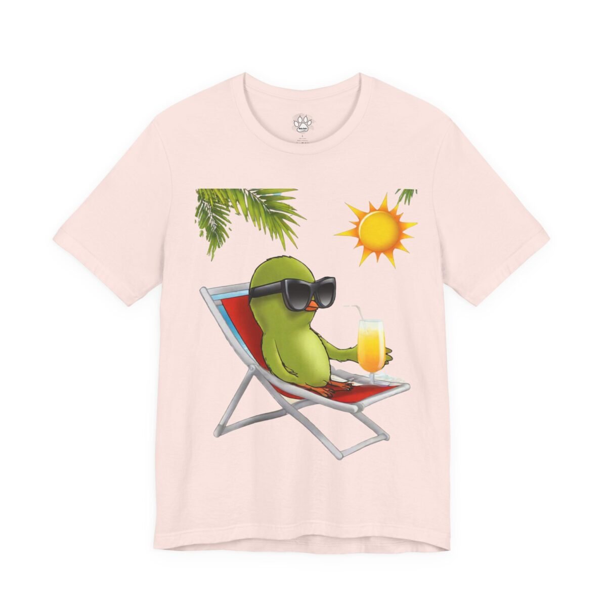 13942525390472901041_2048.jpeg Light pink t-shirt with a cartoon green bird in sunglasses sitting in a beach chair, holding a drink, with palm leaves and a