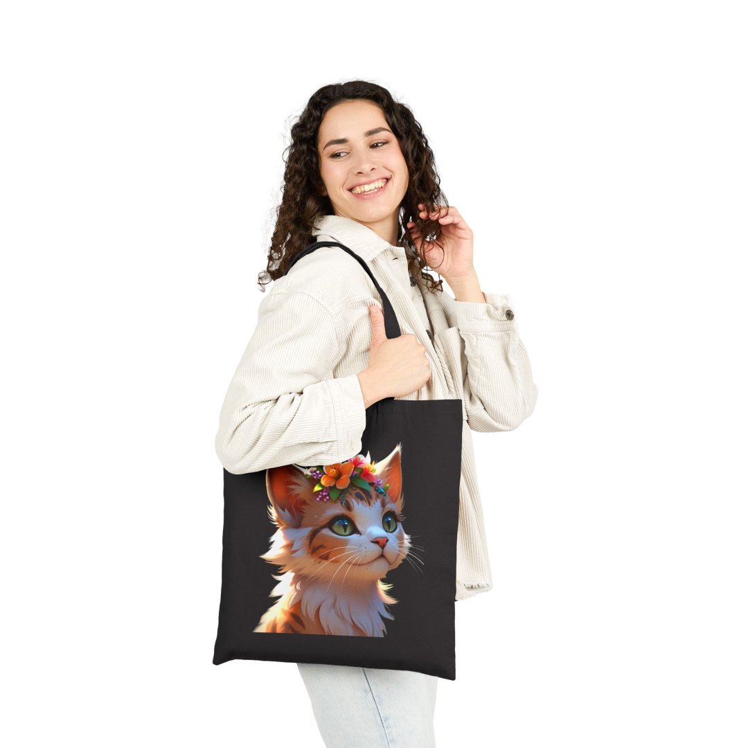 14822983893322402027_2048.jpeg Woman smiling with a tote bag featuring a cute cat illustration.