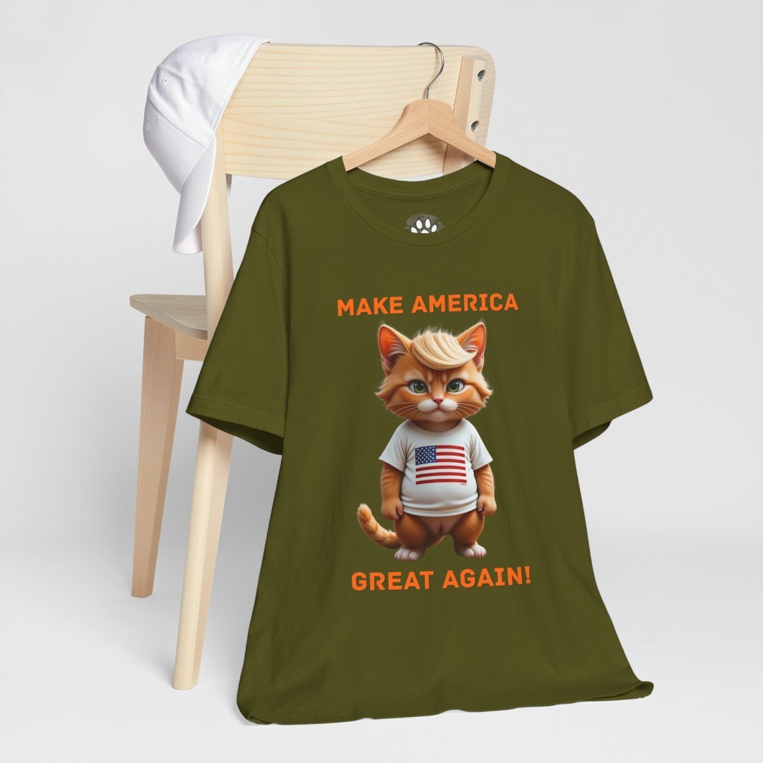 15035655251783449720_2048.jpeg Olive green T-shirt with a cartoon cat wearing a USA shirt.