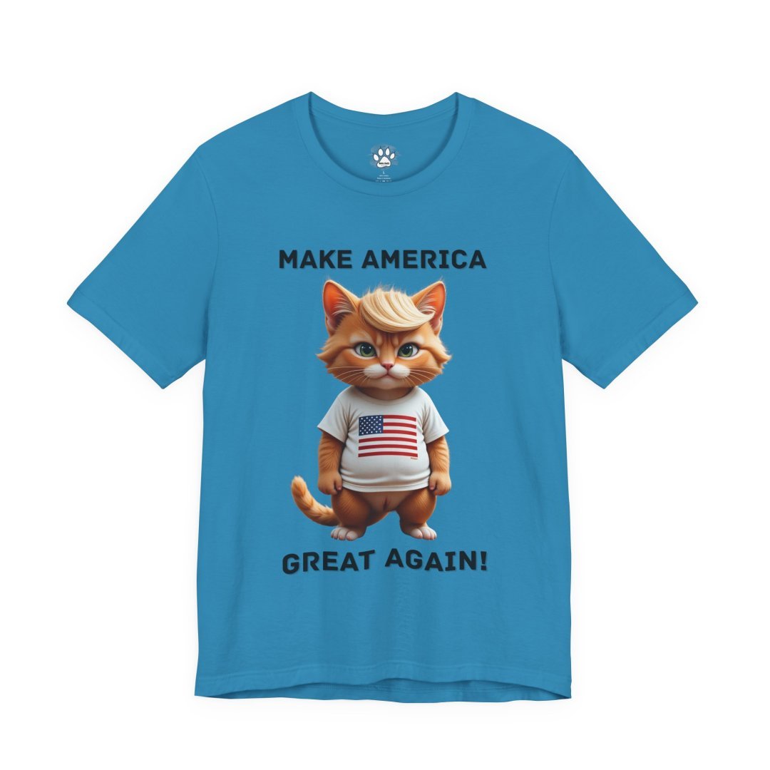 15127998722190995633_2048.jpeg Blue t-shirt with a cartoon cat wearing an American flag shirt and text 'Make America Great Again'.