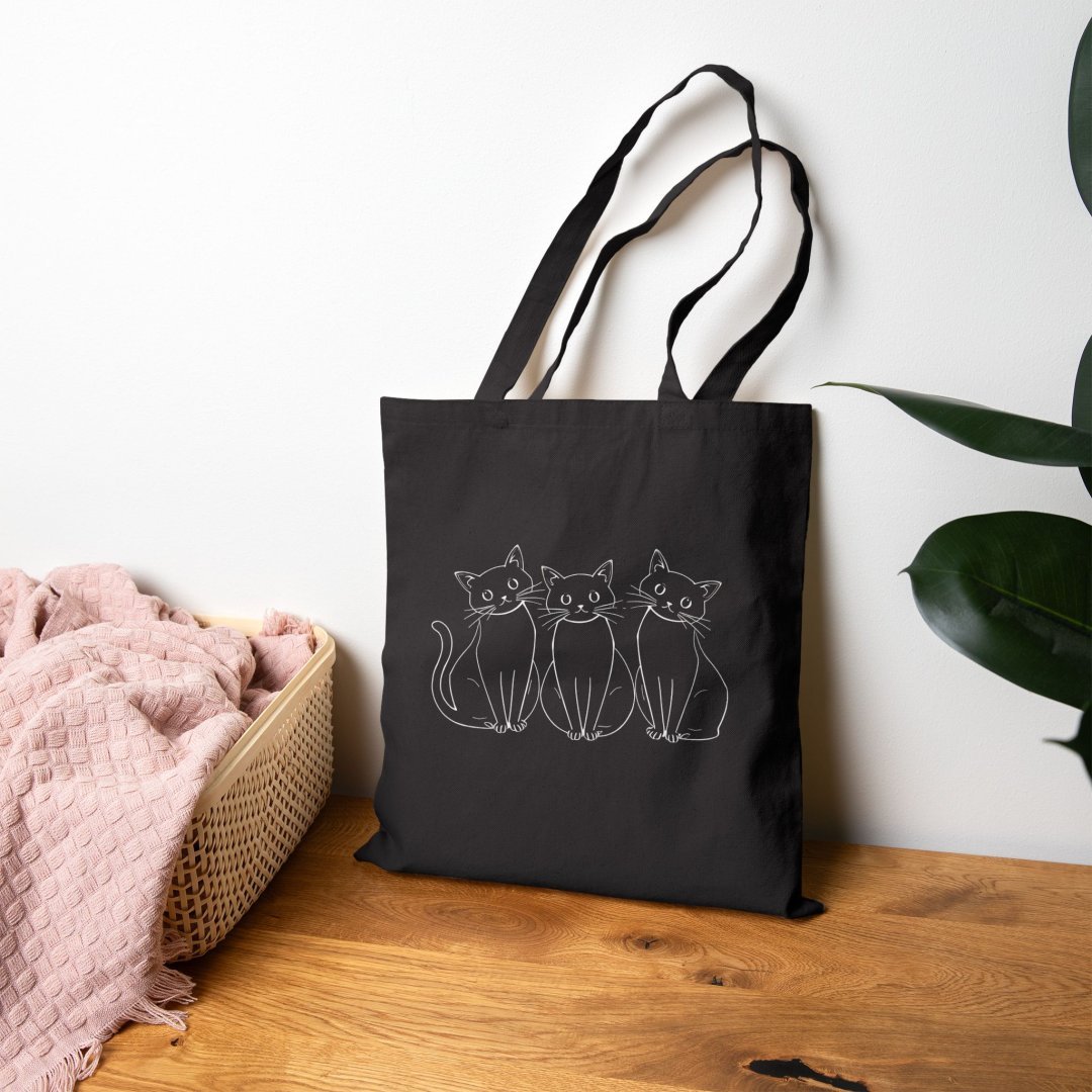 15636298335107630577_2048.jpeg Black tote bag with three outlined cats design.