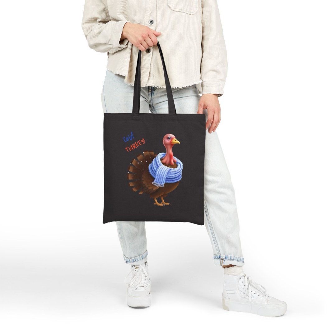 17685190378283323037_2048.jpeg Person holding a black tote bag with a turkey wearing a scarf.