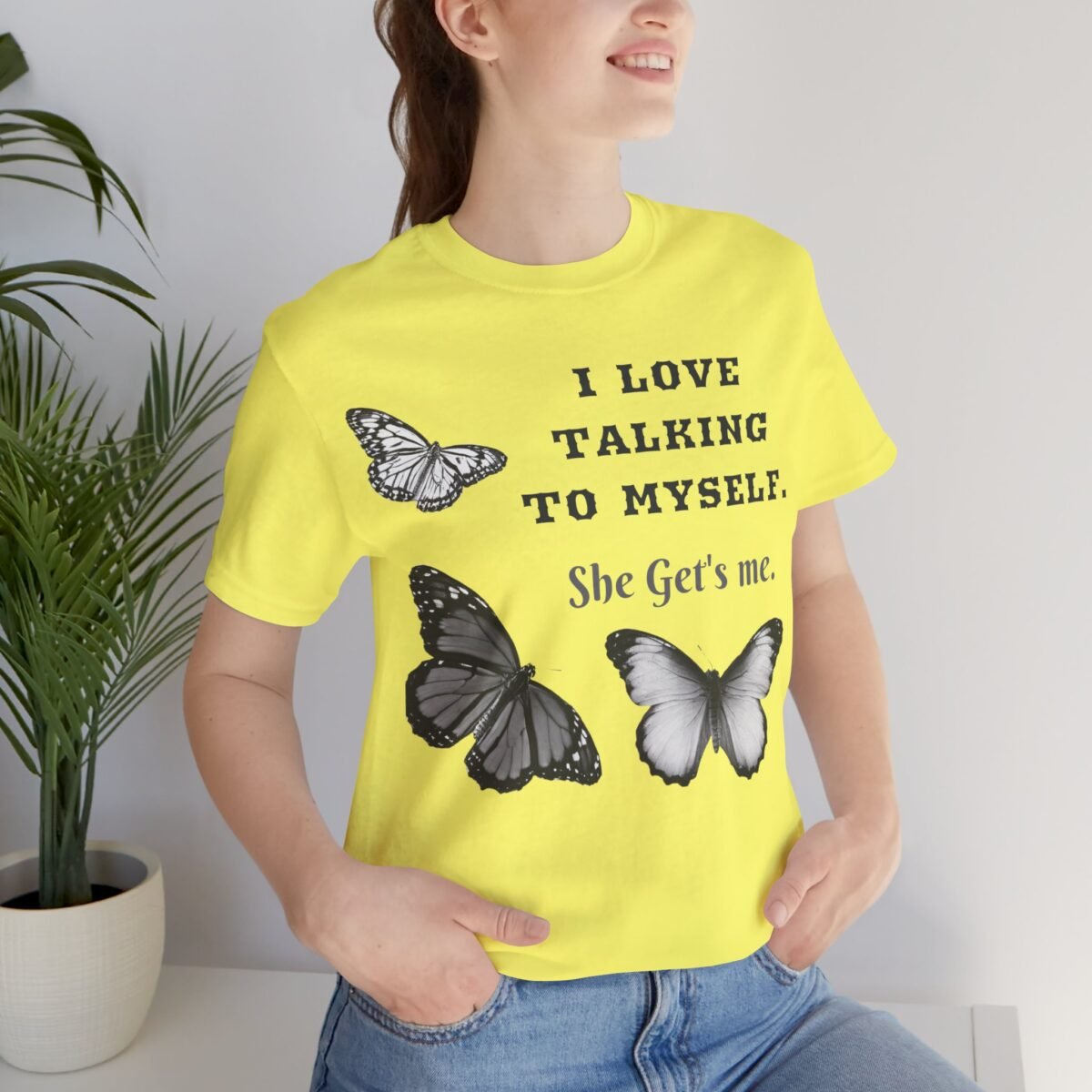 3003737823830478064_2048.jpeg Smiling woman wearing a bright yellow t-shirt with "I LOVE TALKING TO MYSELF. She Gets me." and three black and white