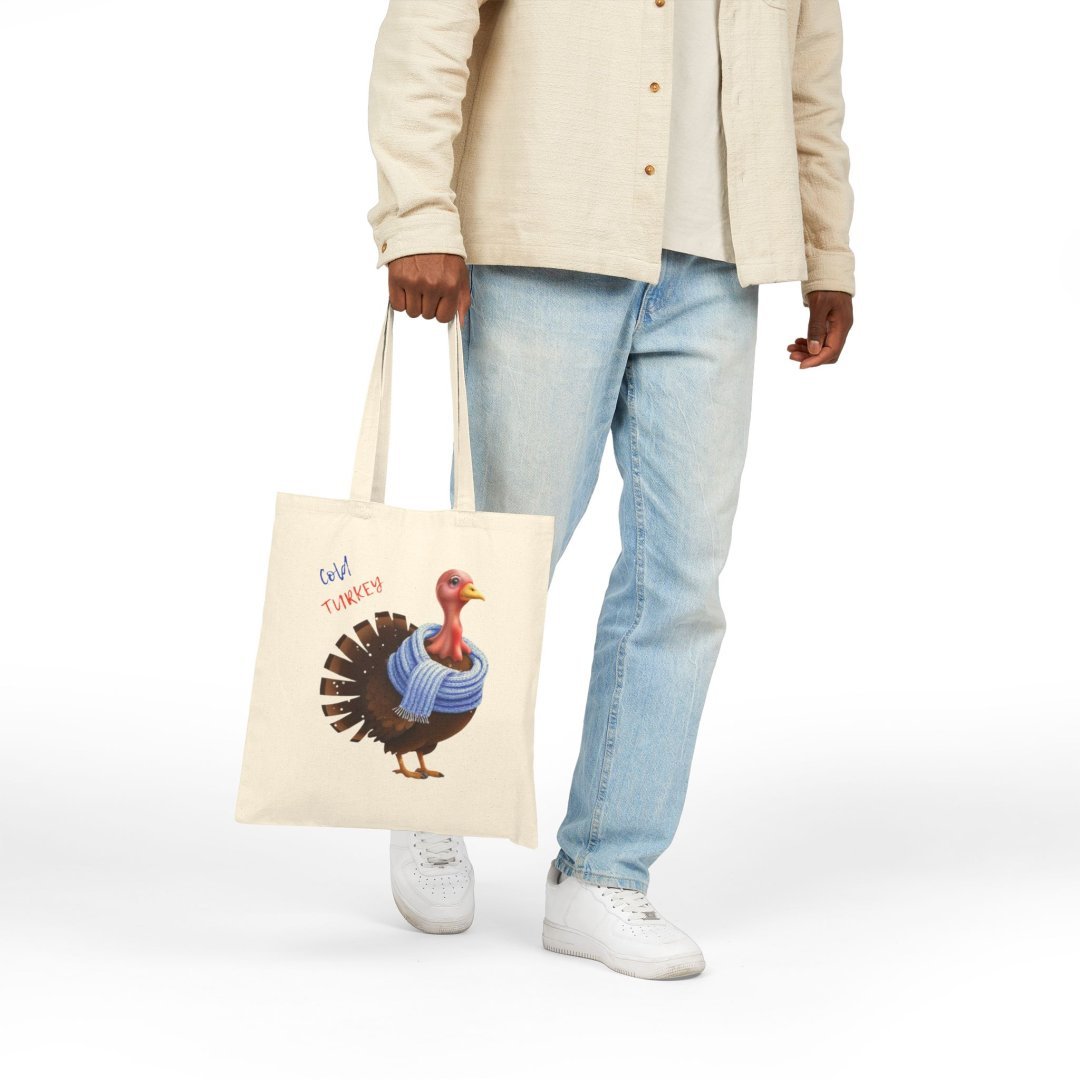 3271865254070708352_2048.jpeg Person holding a tote bag with a turkey wearing a blue scarf.