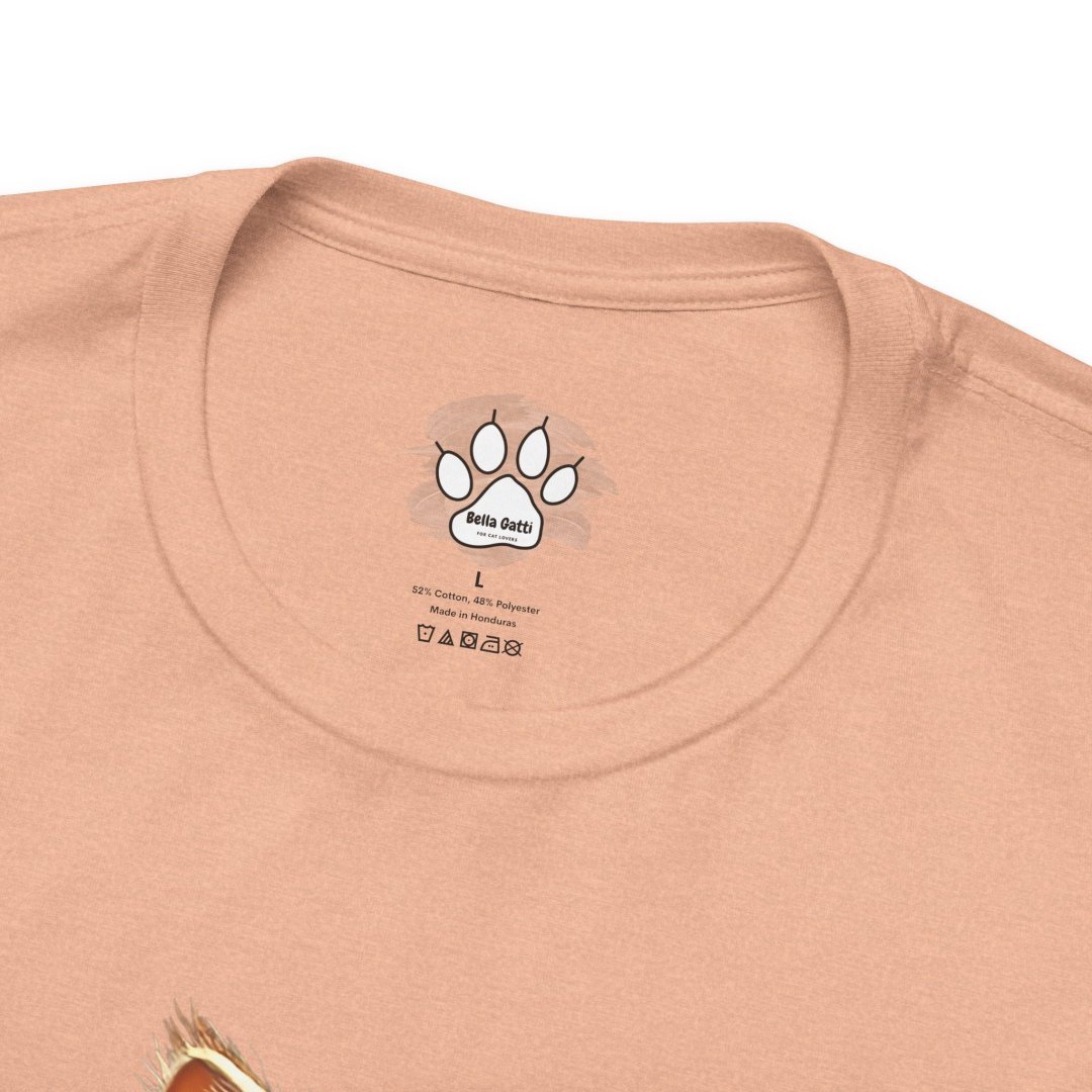 3984639611971262520_2048.jpeg Close-up of a peach-colored Bella Gatti t-shirt with a paw print logo on the label.