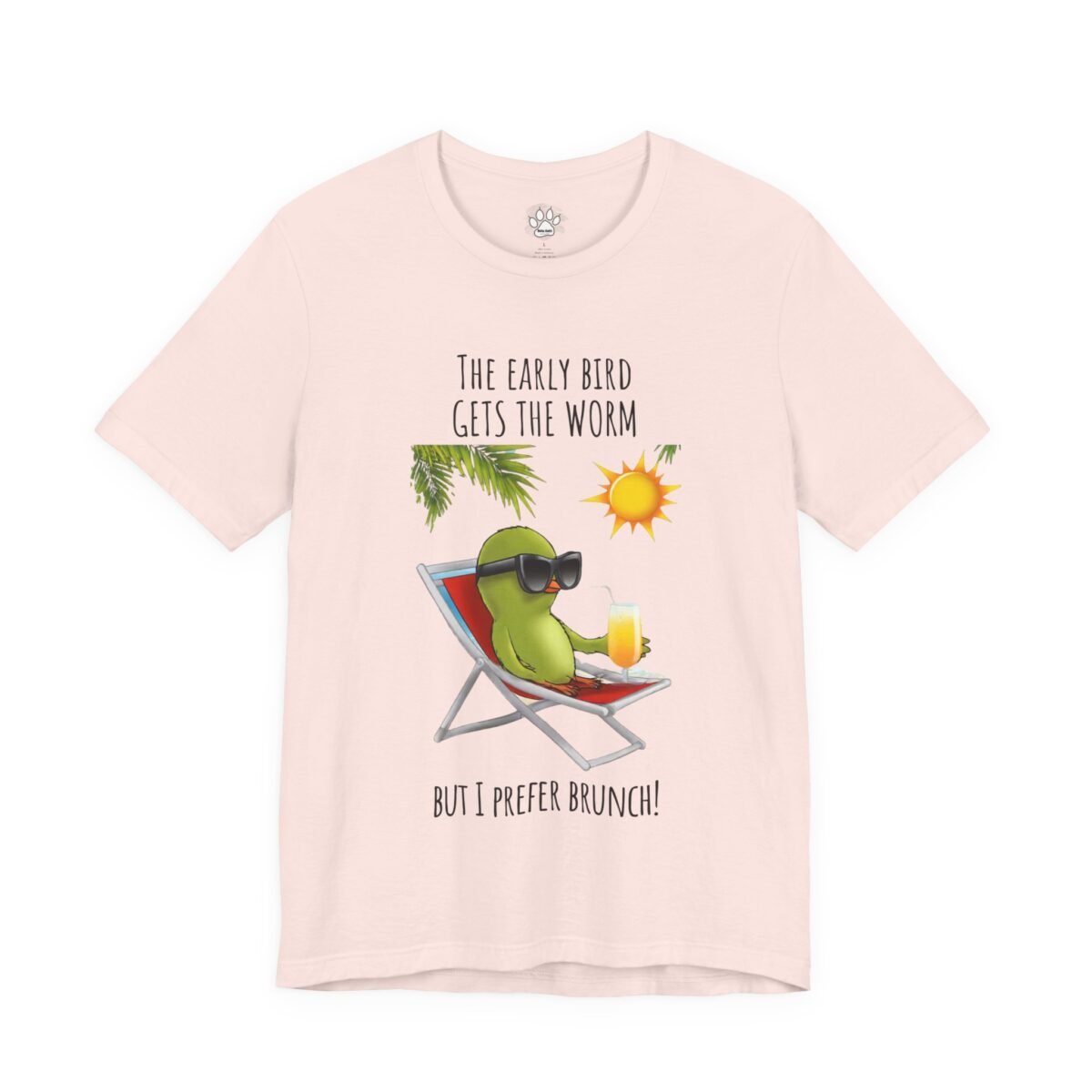 4733111201858566764_2048.jpeg Pink t-shirt with a green bird wearing sunglasses, lounging with a drink, and the text 'THE EARLY BIRD GETS THE WORM BUT I