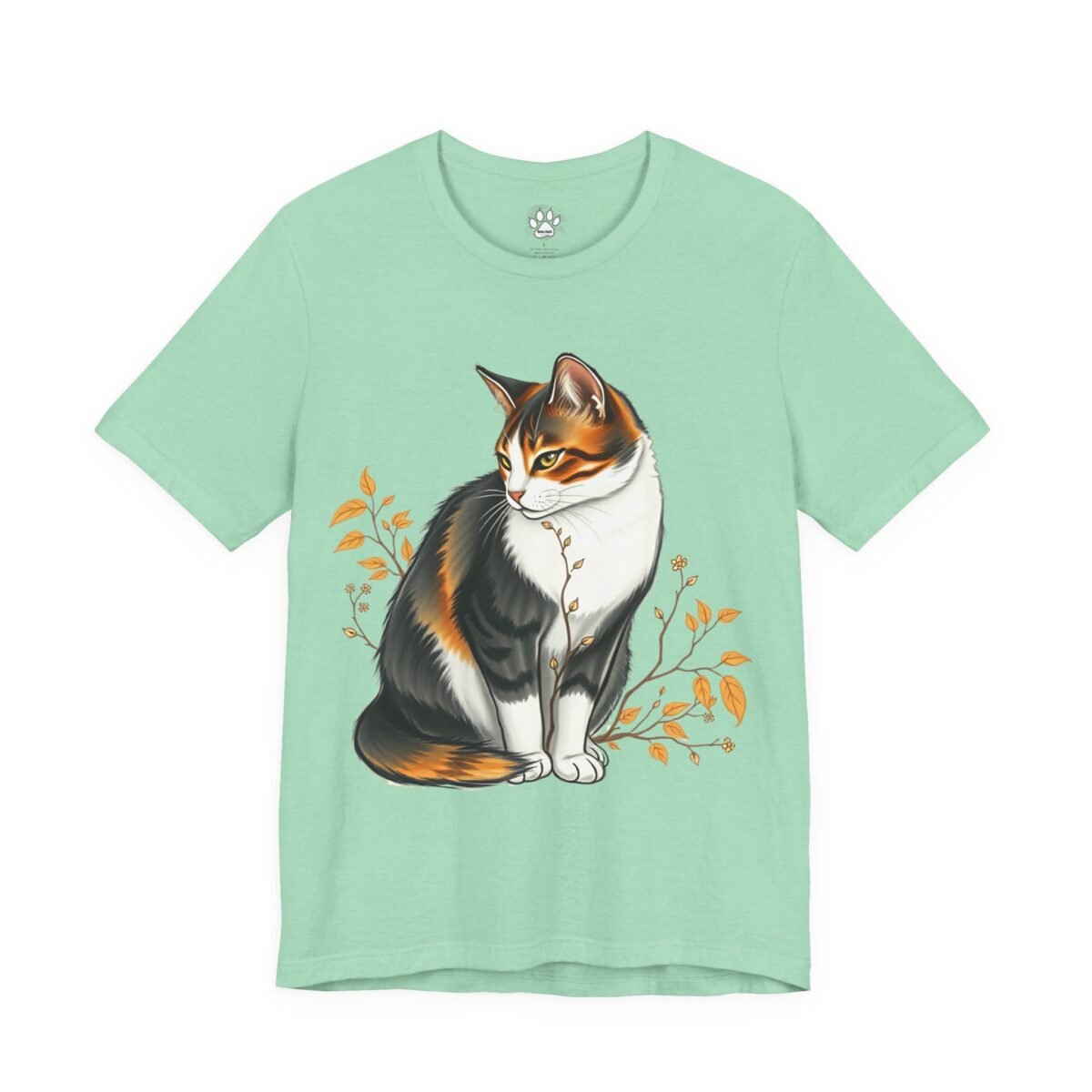 Mint green t-shirt with a calico cat surrounded by autumn branches. Calico Garden Cat Graphic Tee