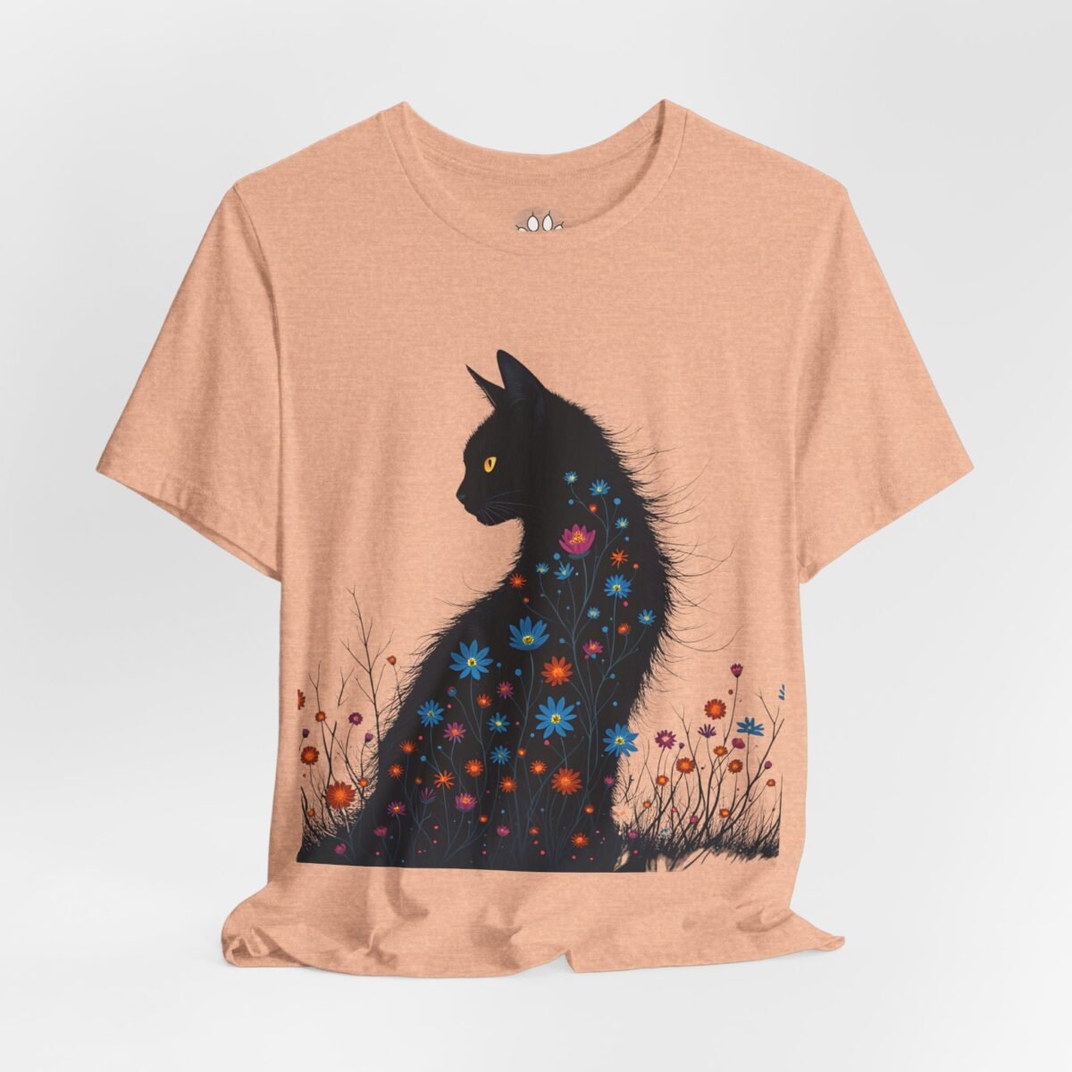 6149991199082879306_2048.jpeg Light orange t-shirt featuring a black cat silhouette filled with vibrant flowers and yellow eyes.