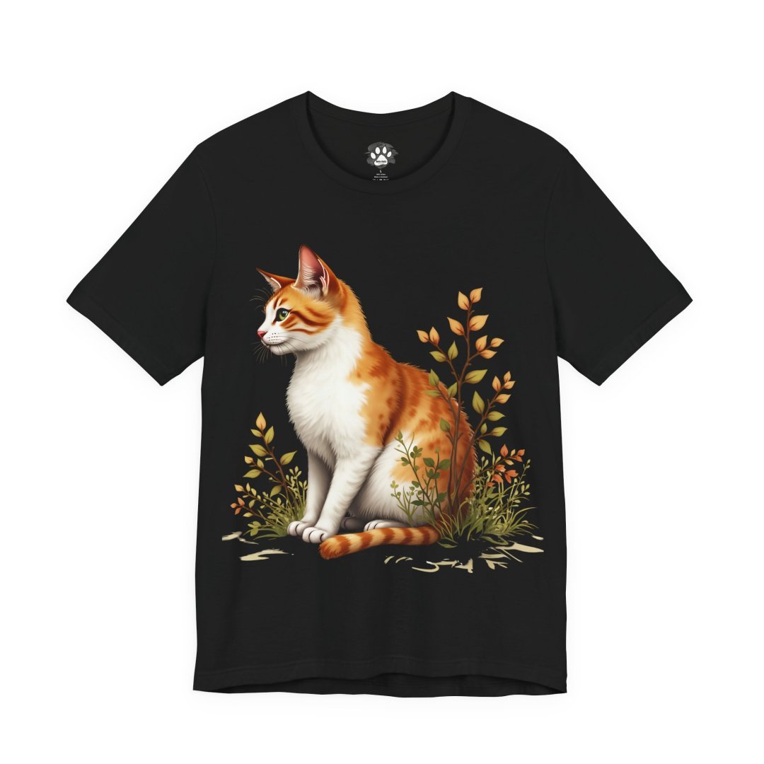 Garden Cat Graphic T-Shirt. Black T-shirt with a print of an orange and white cat sitting among plants.