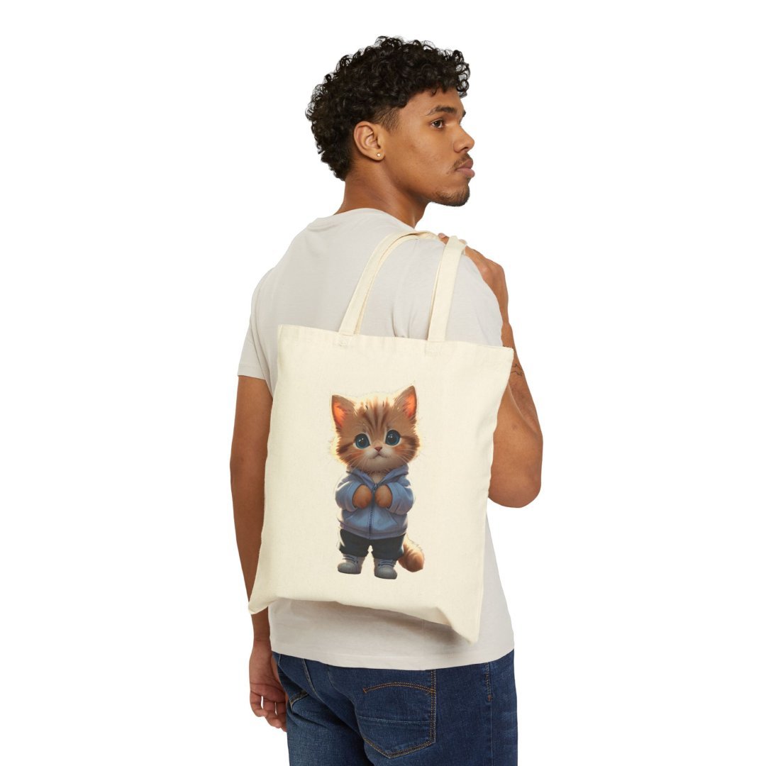 7750182486470538627_2048.jpeg Man carrying a tote bag with a cute cat illustration.