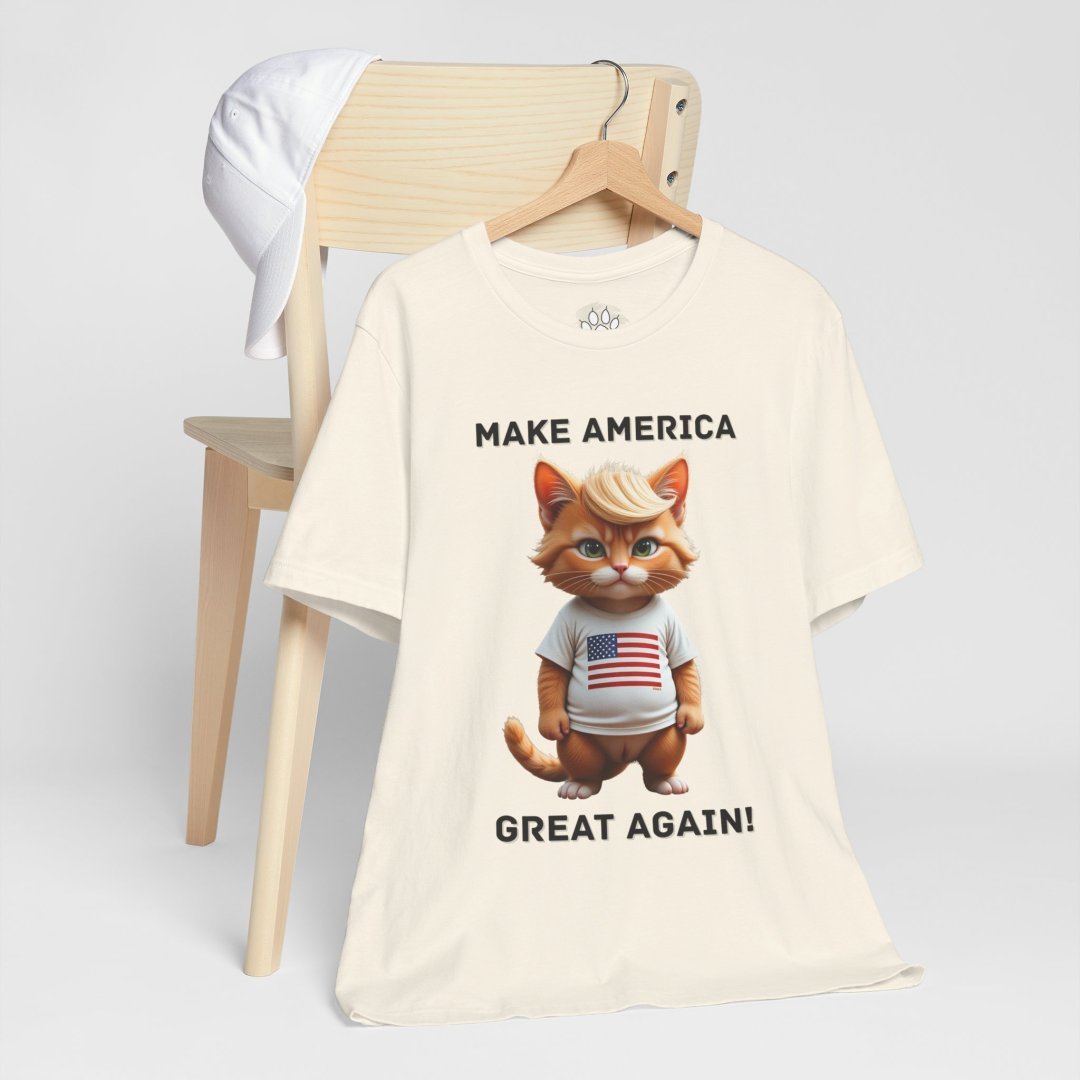 8329318337014758163_2048.jpeg T-shirt with a cartoon cat wearing an American flag shirt and a cap on a chair.