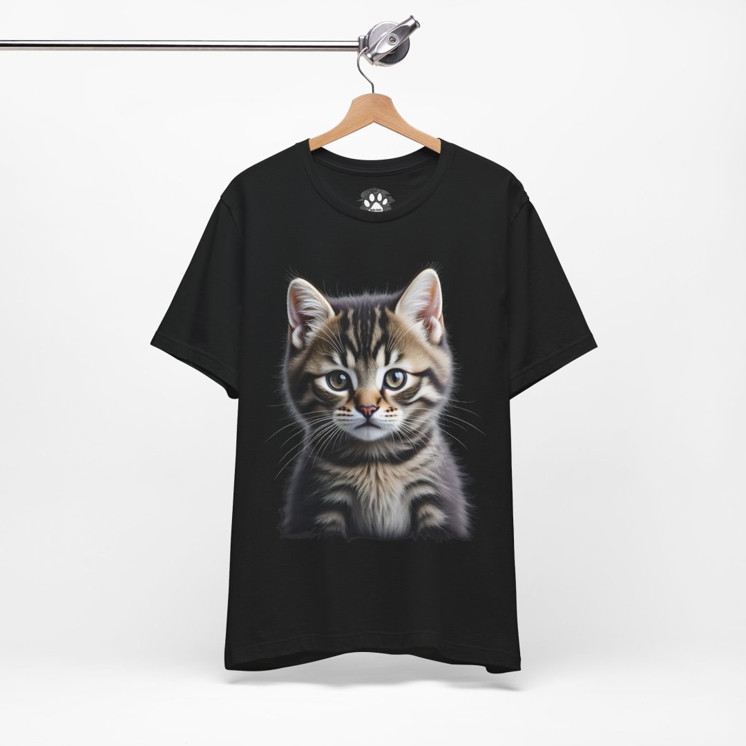 8469372821177959848_2048.jpeg Black T-shirt with a realistic kitten print hanging on a wooden hanger.