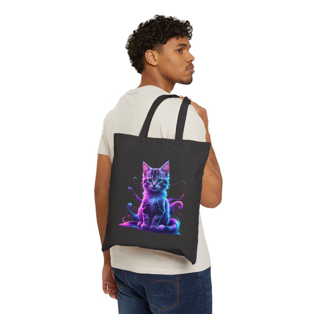 9260030310621601526_2048.jpeg Man carrying a black tote bag with a colorful cat design.