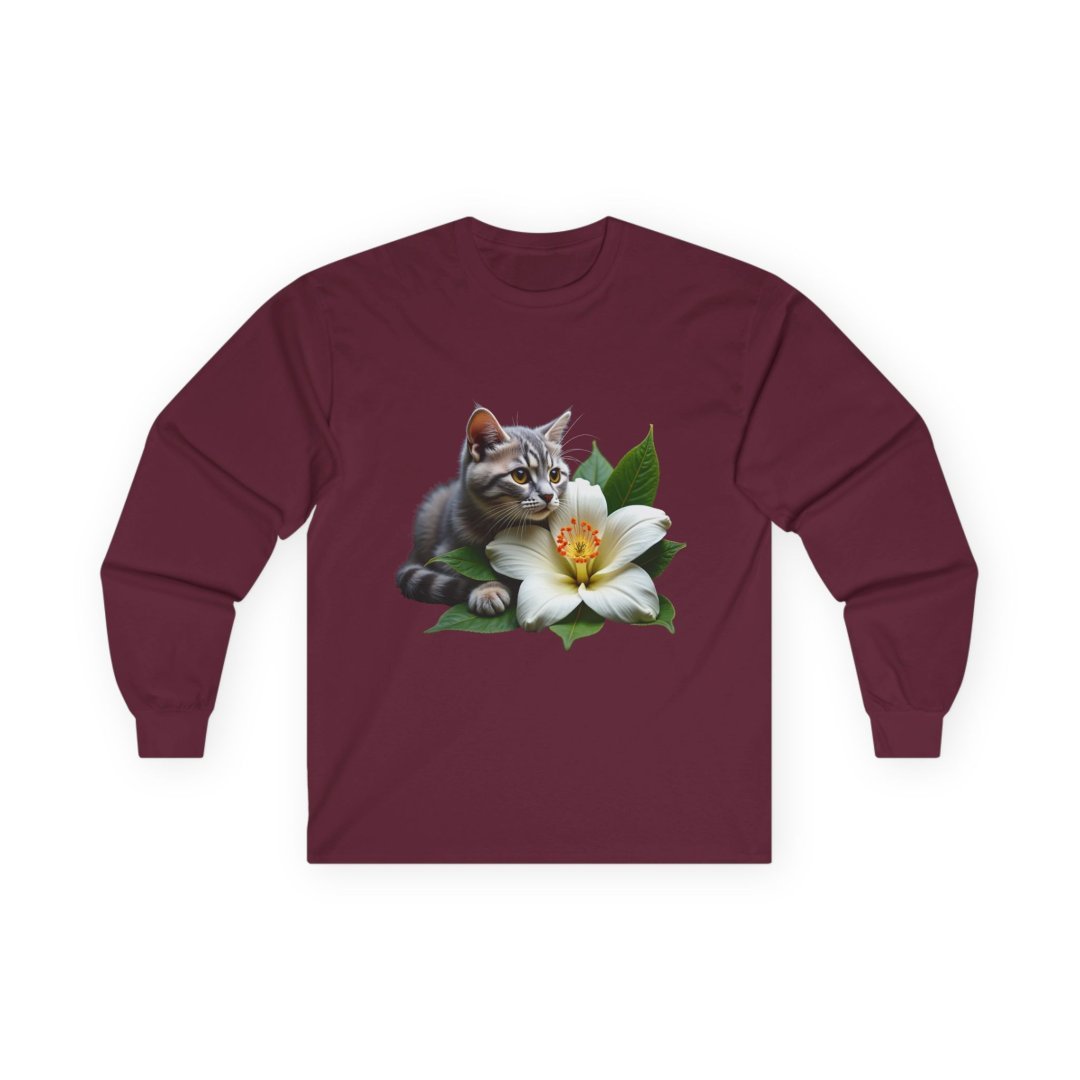 10487299783812772936_2048.jpeg Gray kitten with a white lily on a maroon long-sleeve shirt.