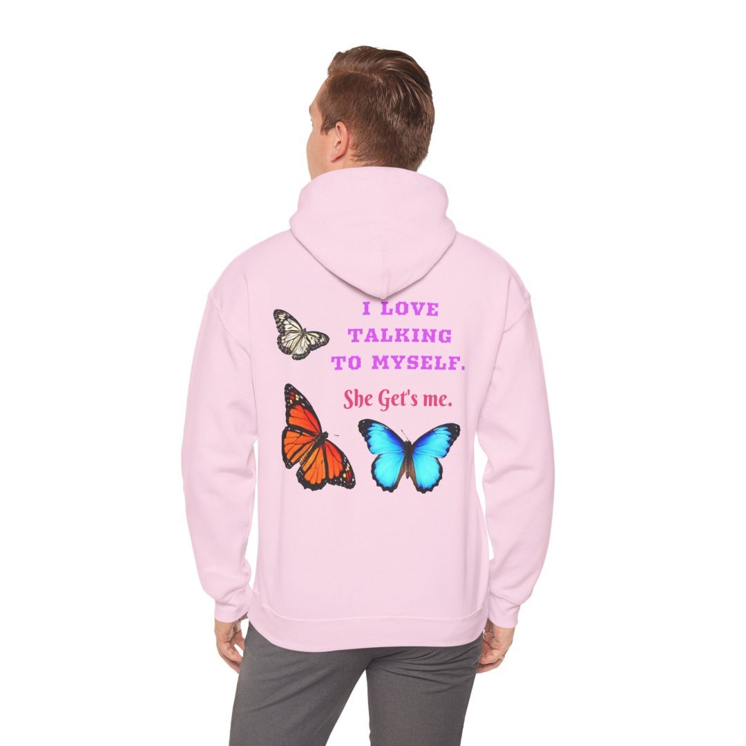 12658306992881793711_2048.jpeg Person wearing a pink hoodie with butterfly designs and text.