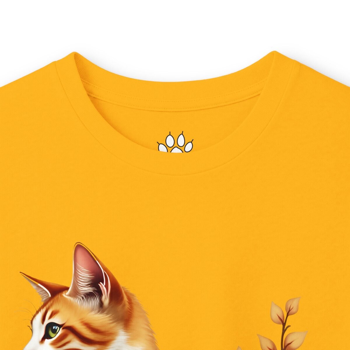 13550426325463773790_2048.jpeg Yellow t-shirt featuring an orange cat and autumn leaves, with a paw print inside the collar.
