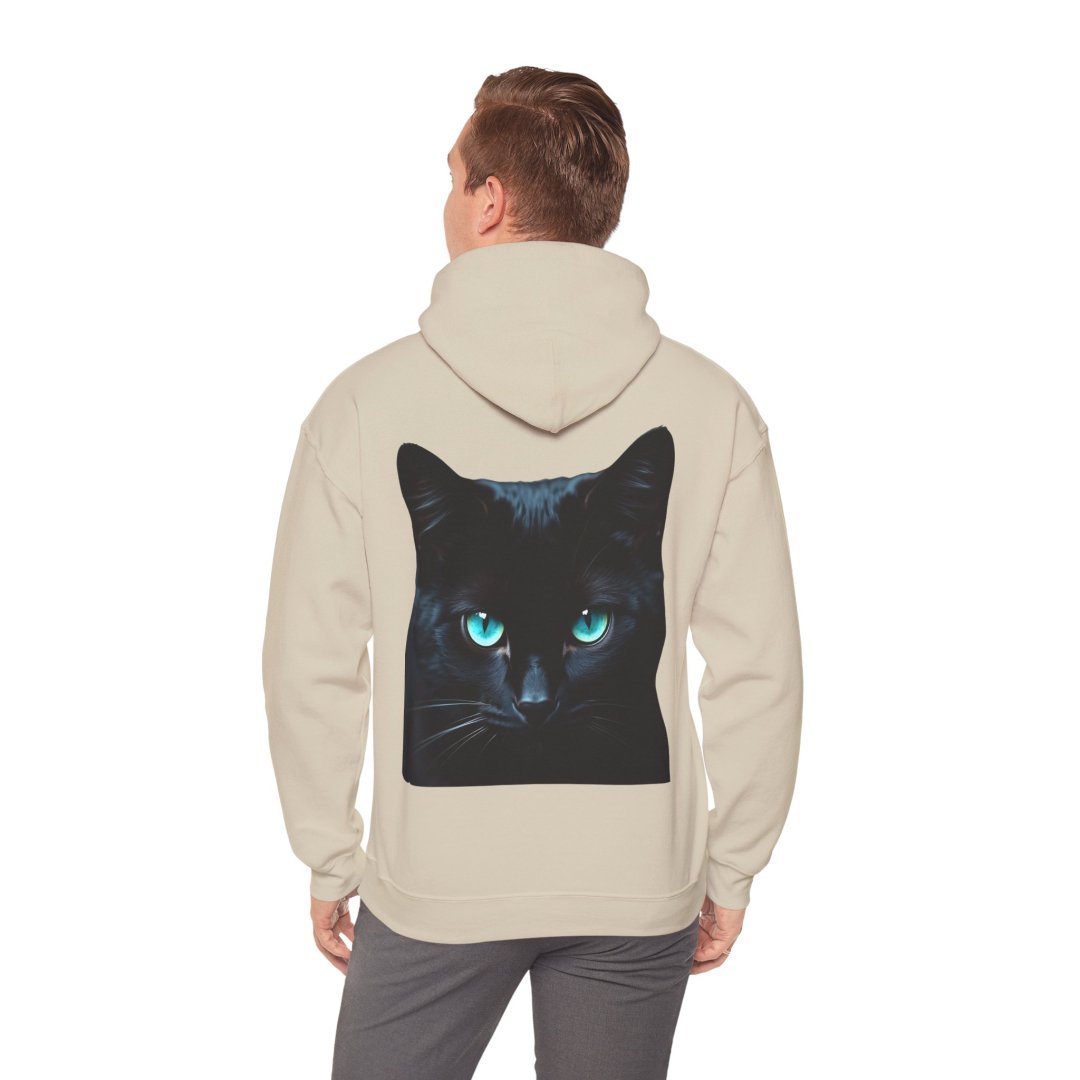 13915176385081739037_2048.jpeg Person wearing a beige hoodie with a black cat design on the back.