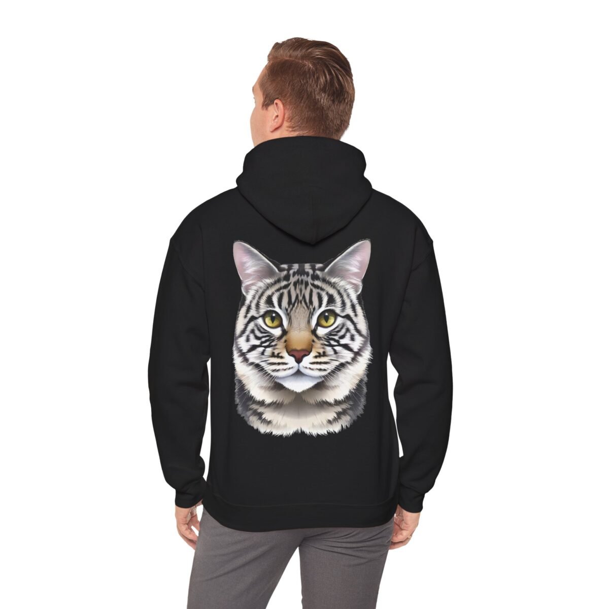 9784829968270164596_2048.jpeg Person in a black hoodie with a detailed tabby cat face printed on the back.